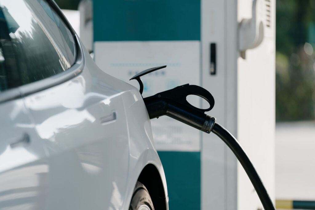 Electric car is charging at charging station