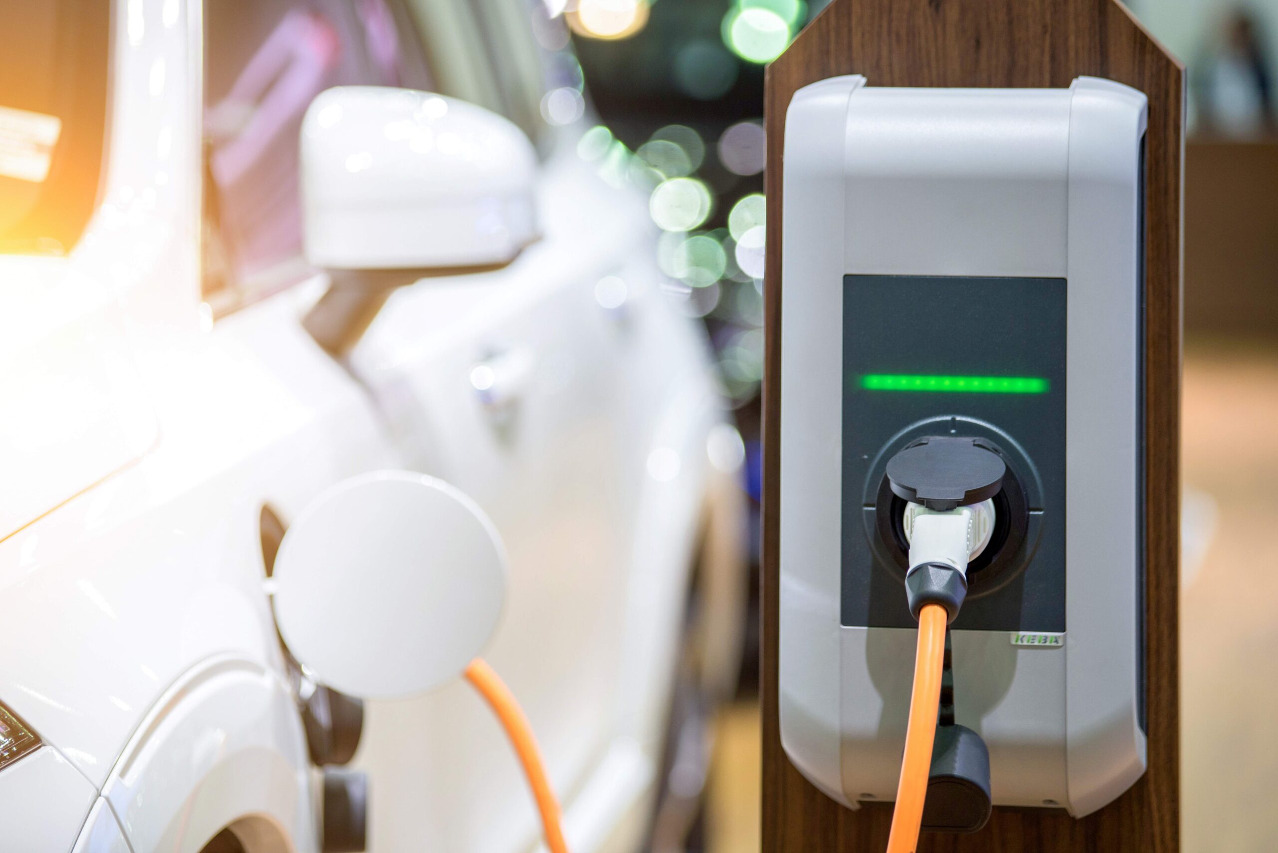 Electric car charging plugged to a charging station